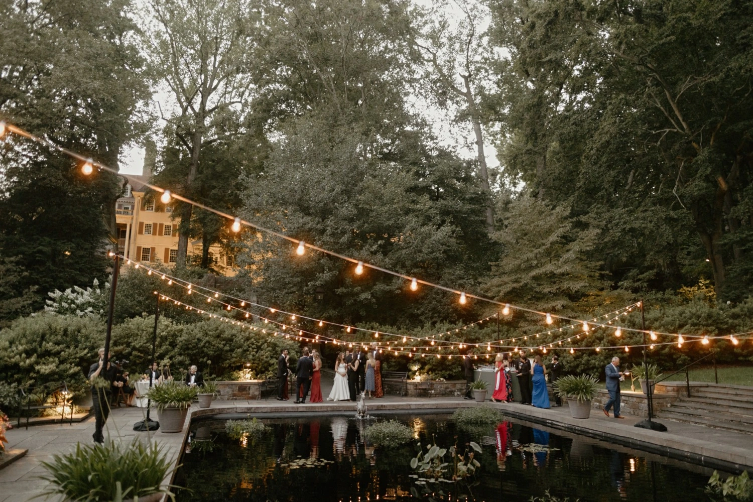 Lighting over reflecting pool by collective event group