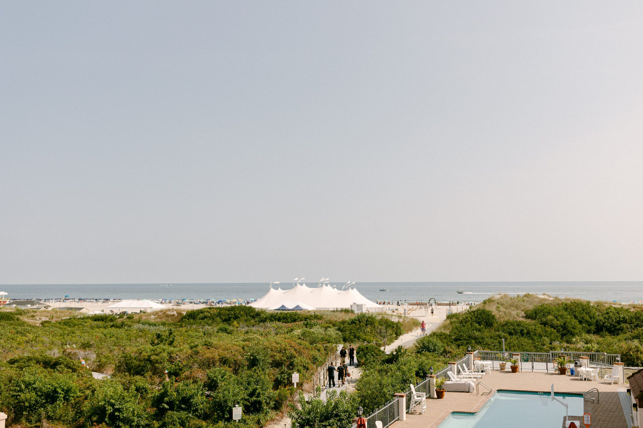 drone view of wildwood new jersey shoreline with silhouette of white wedding tent