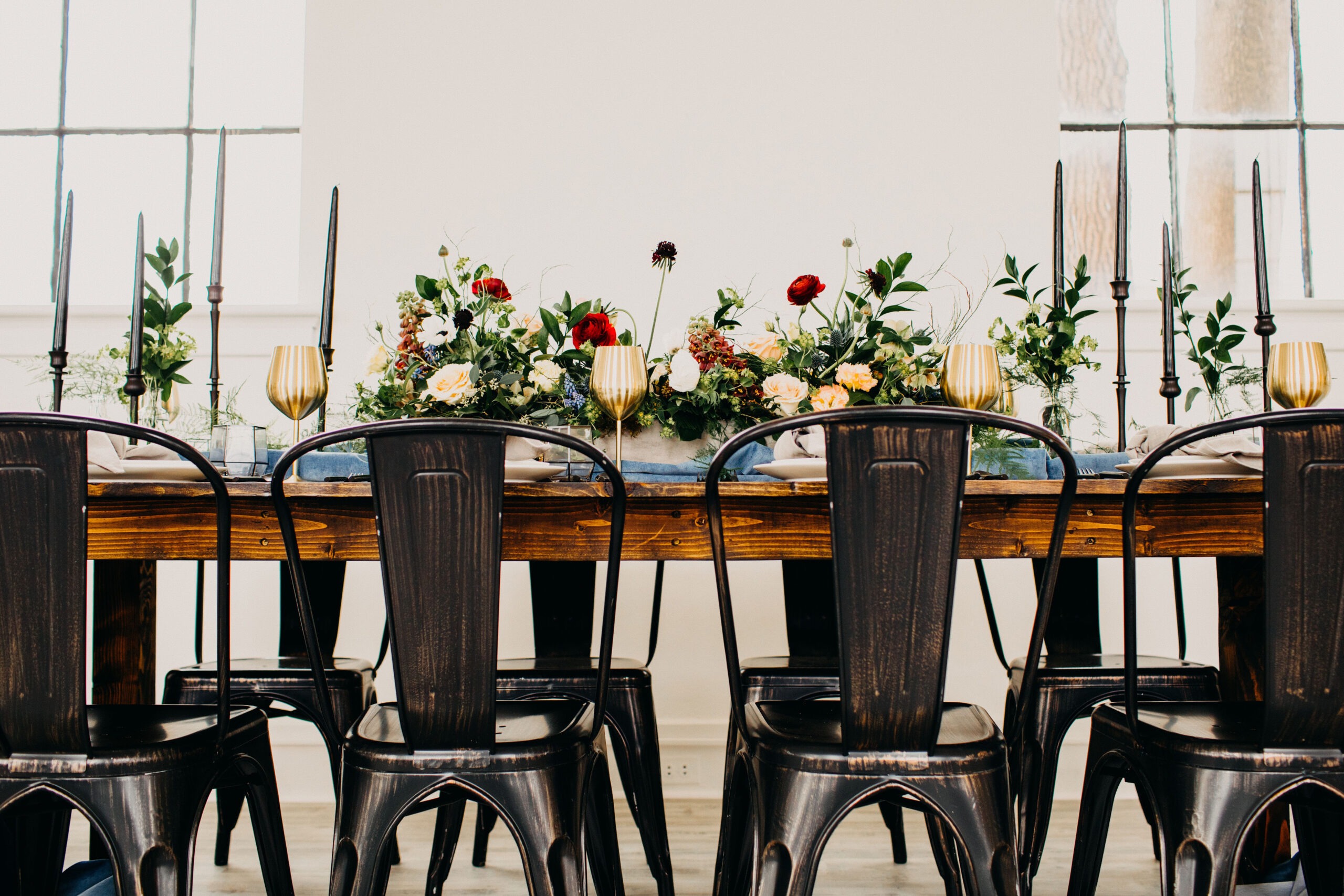 Bistro-Harvest-Tables-1024x683-1 Wood harvest tables with black metal chairs, gold glassware and floral centerpieces