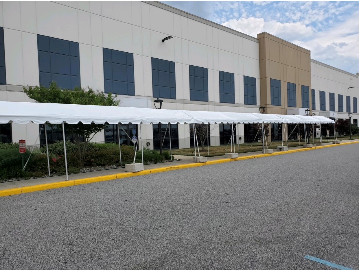 Marquee Tent set up on sidewalk in front of office building