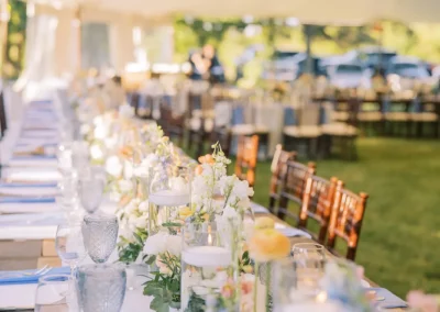 Blue Glassware and place settings set up on a king table for Wedding Reception