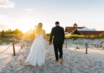 couple walking on beach wedding dress