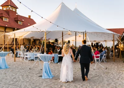 bride and groom walking to wedding tent