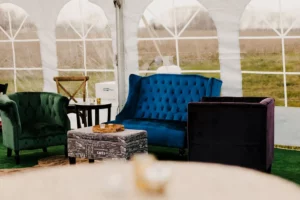 lounge furniture seating area set up under a wedding reception tent