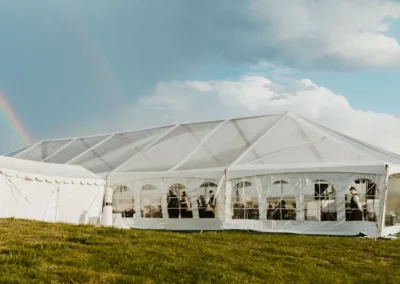 clear top wedding tent with marquee with rainbow in background