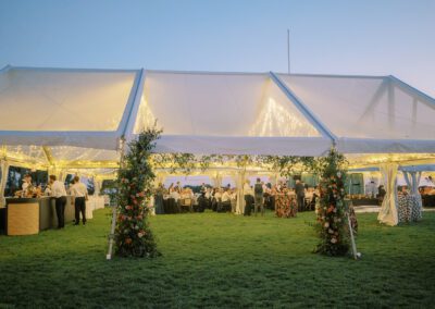 clear tent with lighting on green grass at dusk