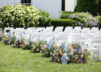wedding ceremony with white padded chairs