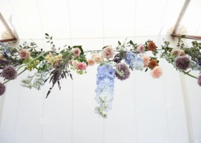 flowers hanging in wedding tent