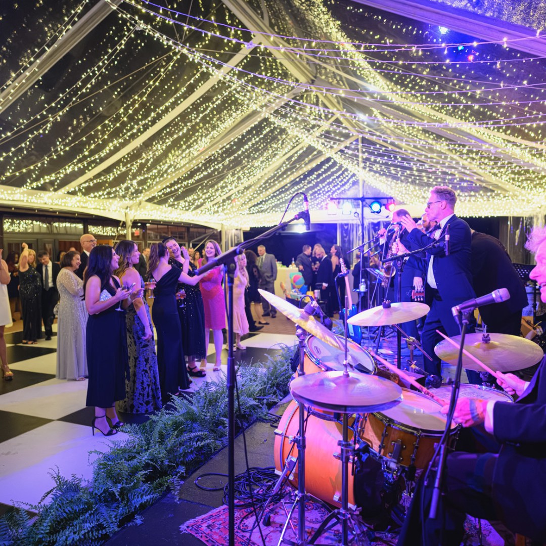 westside gala3 band stage under clear top tent with twinkle lighting for a fundraising gala in Wilmington Delaware