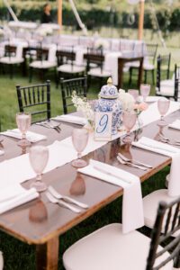 farmhouse table with pink goblets and black chairs