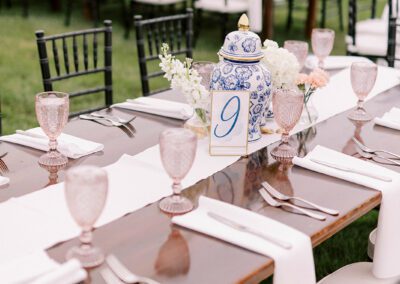 farmhouse table with pink goblets and black chairs