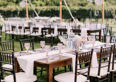 farmhouse tables with black chairs set up for wedding reception