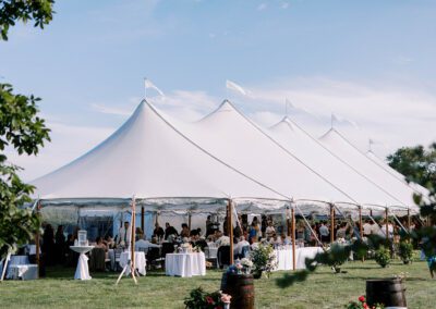 large white wedding tent set up for summertime wedding