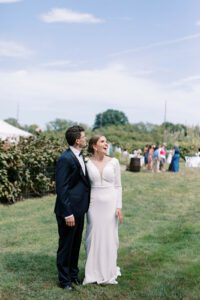 bride and groom gazing at the blue sky