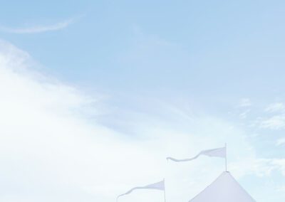 flags on the points of a sailcloth tent flowing in breeze under a blue sky