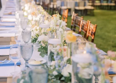 Blue Glassware and place settings set up on a king table for Wedding Reception
