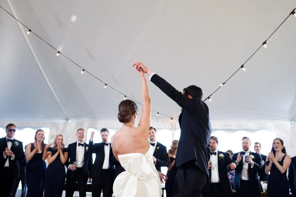 bride and groom under tent