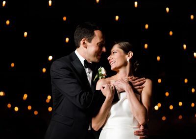 bride and groom photo under twinkle lights