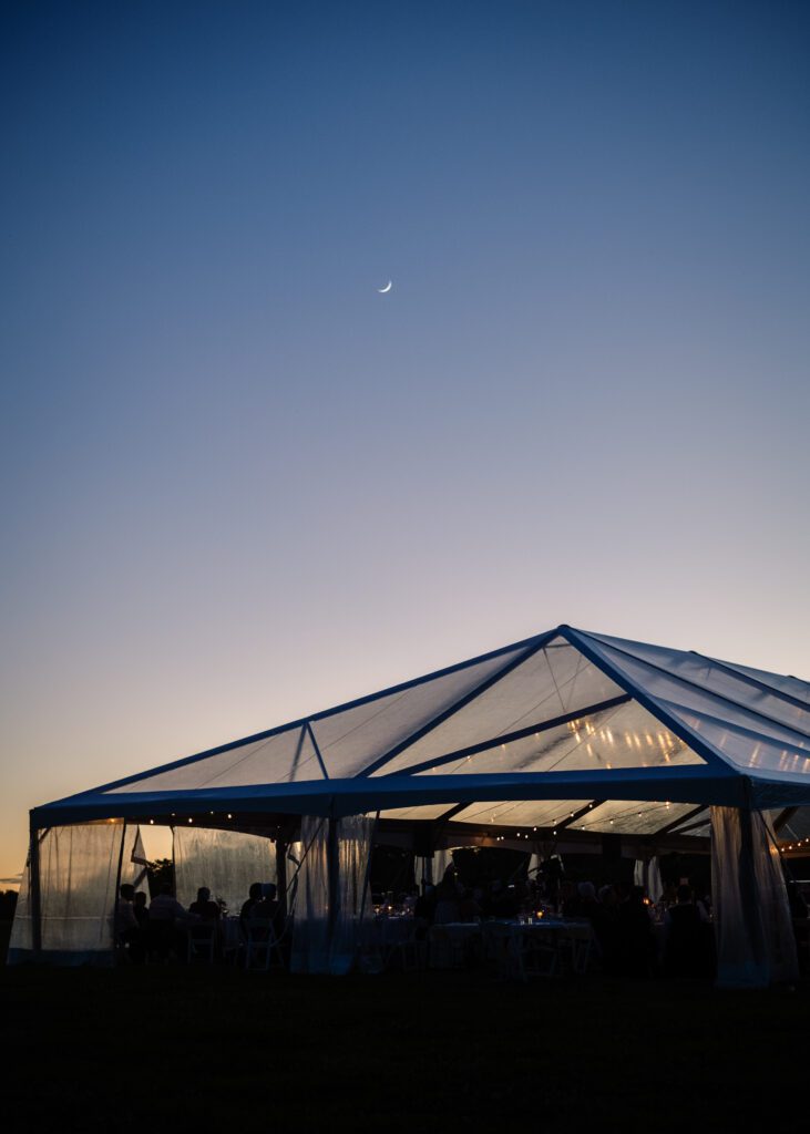 clear top frame tent, hip end at dusk with sunset in background