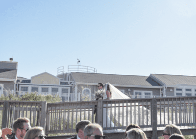 Bride and Groom entering beach from Childrens Beach House
