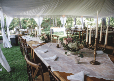 Inside a frame tent with a liner, view of a farm table