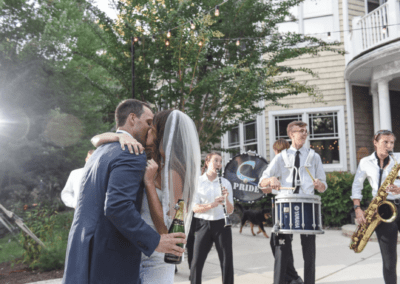 Bride and Groom kissing with outdoor band