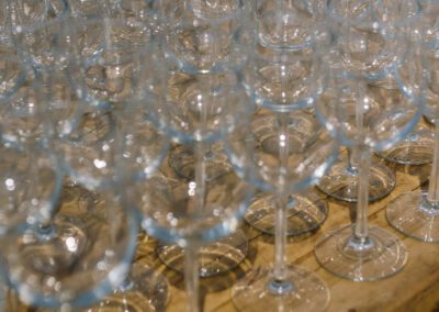 wine glasses lined up on wooden table