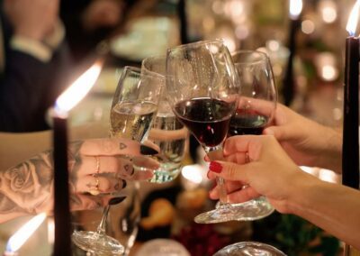 guests celebrating during dinner holding wine glasses