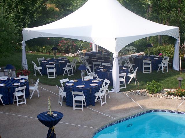 20x20 high peak tent set up poolside for backyard party