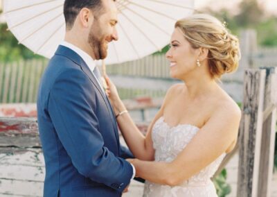 bride and groom holding umbrella