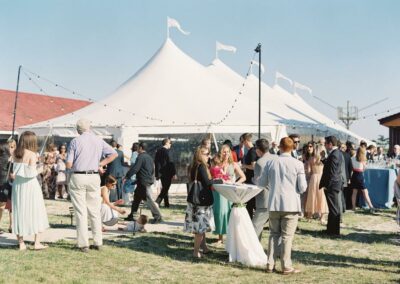 guests enjoying cocktail hour outside of wedding tent