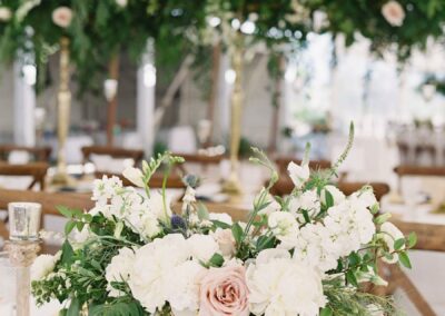 tented beach wedding tablescape with florals and greenery
