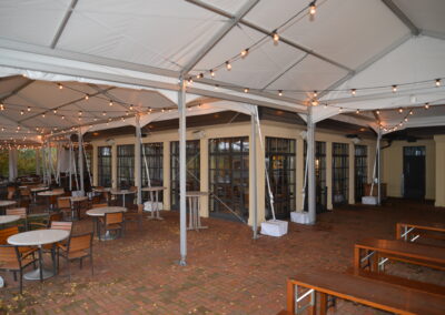 Custom designed navitrac tents over brick patio along building