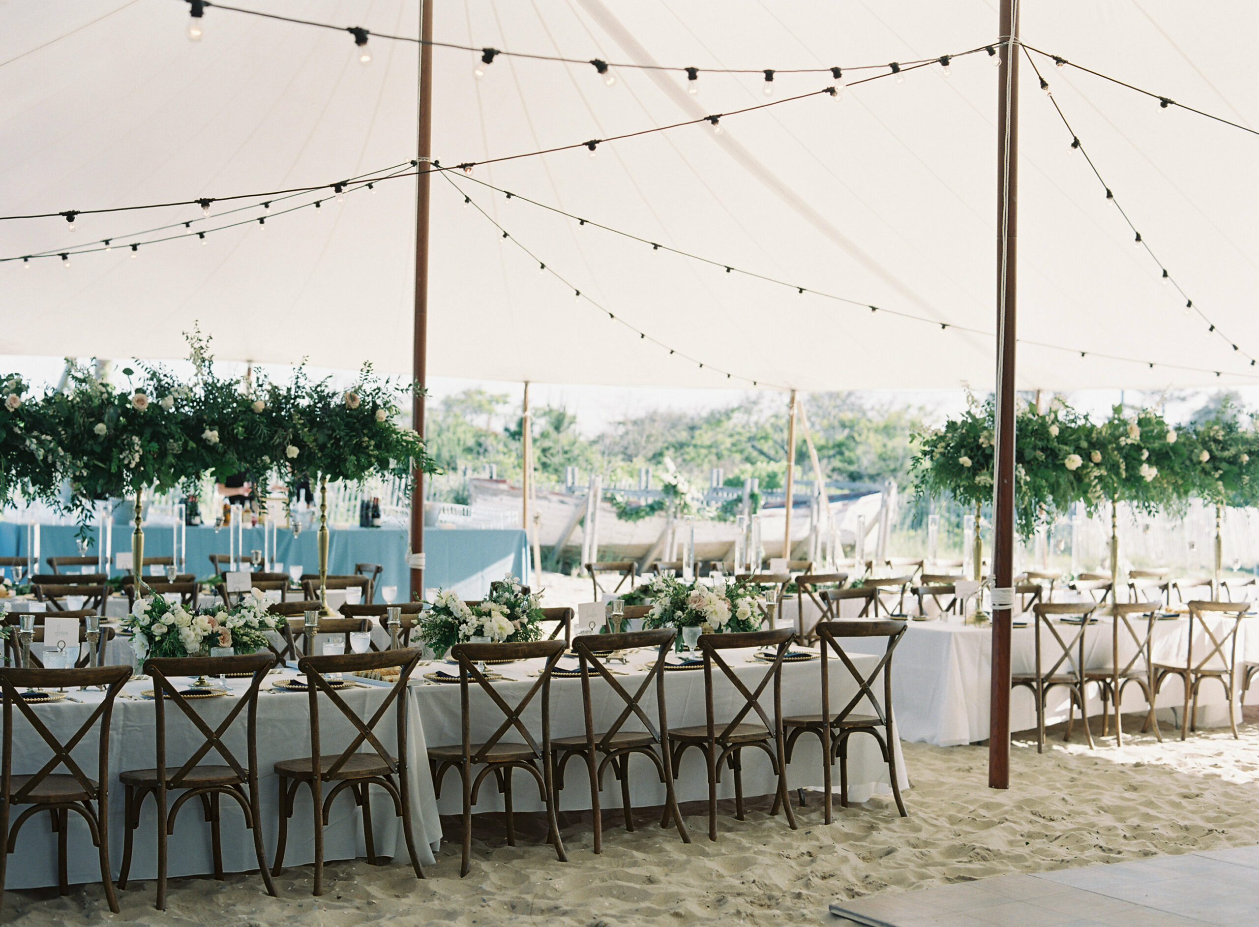 Crossback chairs and white and green setting under a sailcloth tent at IRLSS