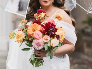 Bride carrying bright floral bouquet at Winterthur
