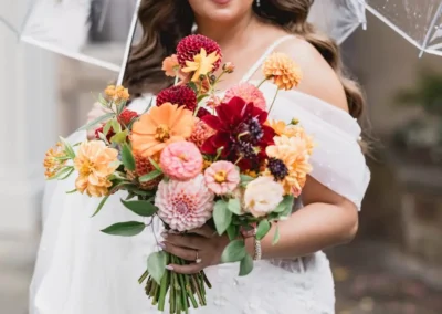 Bride carrying bright floral bouquet at Winterthur