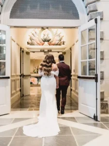 bride and groom walking into winterthur indoors