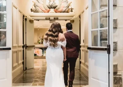 bride and groom walking into winterthur indoors