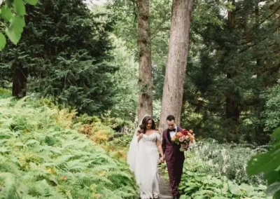 bride and groom walking through winterthur gardens