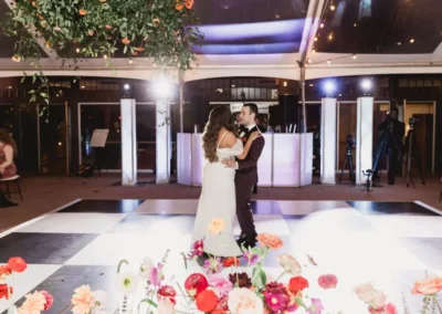 first dance on a black and white checkered dance floor under a cleartop tent at winterthur