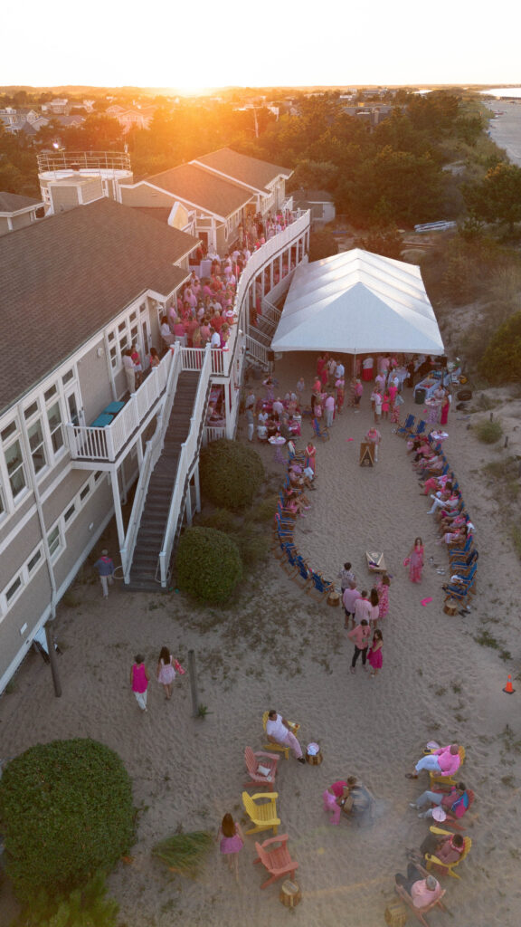 overhead photo looking down on a sandy beach with a white tent
