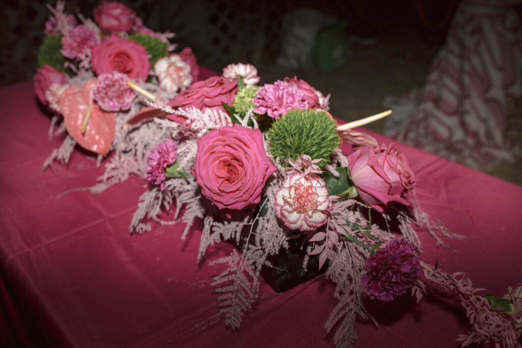 pink rose flower arrangement on a table with pink table linen