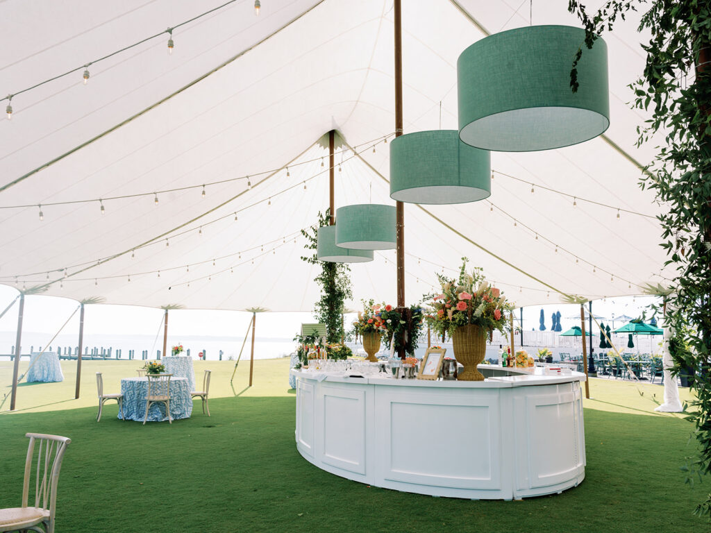 sailcloth wedding tent with large dusty blue drum shades suspended from ceiling