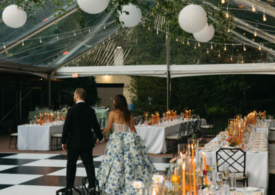 clear top tent with greenery and paper lanterns