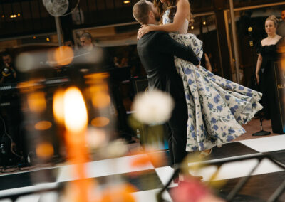 bride and groom dancing on black and white dance floor