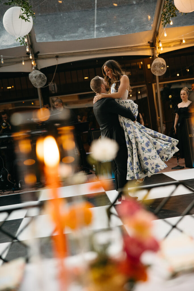 bride and groom dancing on black and white dance floor