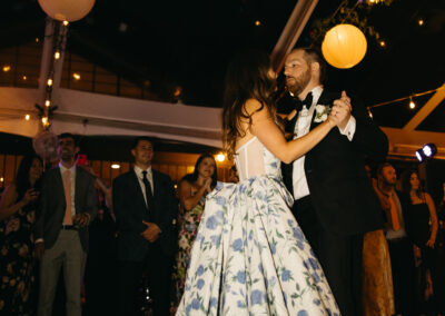 bride and groom dancing under glowing clear top tent