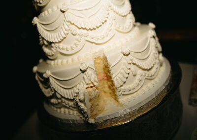 wedding cake with slice cut out of it