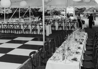 black and white photo of wedding reception under high peak pole tent