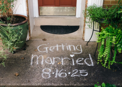 sidewalk chalk on front step with wedding date